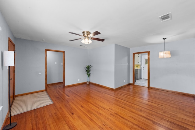 1330 S Pecan St, Arlington, TX 76010 - spare room with visible vents, baseboards, light wood finished floors, and a ceiling fan
