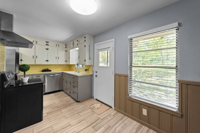 1330 S Pecan St, Arlington, TX 76010 - kitchen featuring wall chimney range hood, light countertops, a wainscoted wall, black electric range oven, and dishwasher