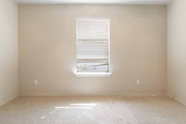 unfurnished room with carpet floors and baseboards