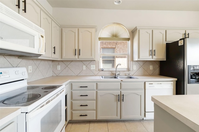 kitchen featuring a sink, light countertops, and white appliances