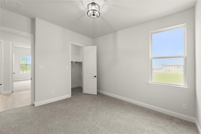 2109 Stratford Rd, Rockwall, TX 75087 - unfurnished bedroom with carpet floors, baseboards, and a walk in closet