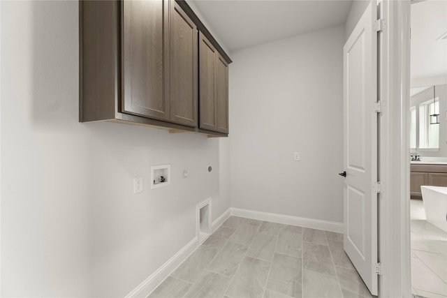 2109 Stratford Rd, Rockwall, TX 75087 - washroom with cabinet space, washer hookup, hookup for an electric dryer, hookup for a gas dryer, and baseboards