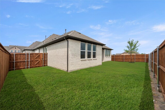 2109 Stratford Rd, Rockwall, TX 75087 - back of house featuring a shingled roof and brick siding