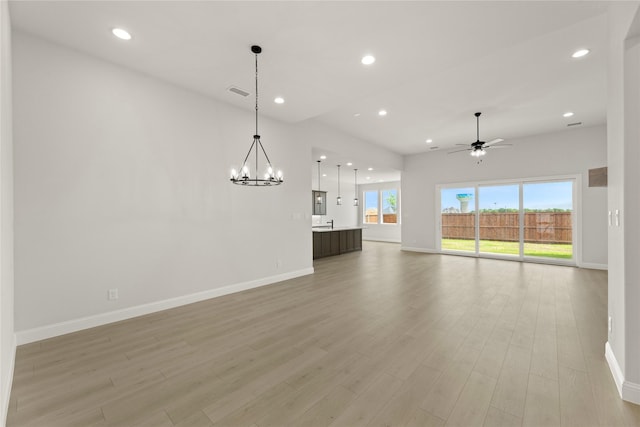 2109 Stratford Rd, Rockwall, TX 75087 - unfurnished living room featuring baseboards, recessed lighting, a chandelier, light wood-type flooring, and a ceiling fan