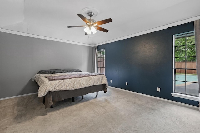 carpeted bedroom with baseboards and ceiling fan