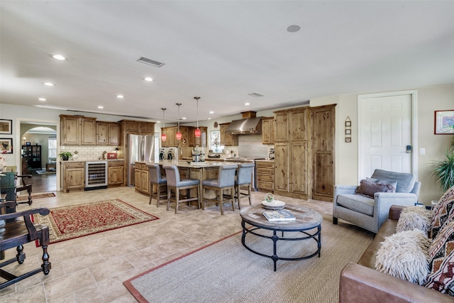 9705 Twin Creek Dr, Dallas, TX 75228 - living area featuring beverage cooler, recessed lighting, and arched walkways