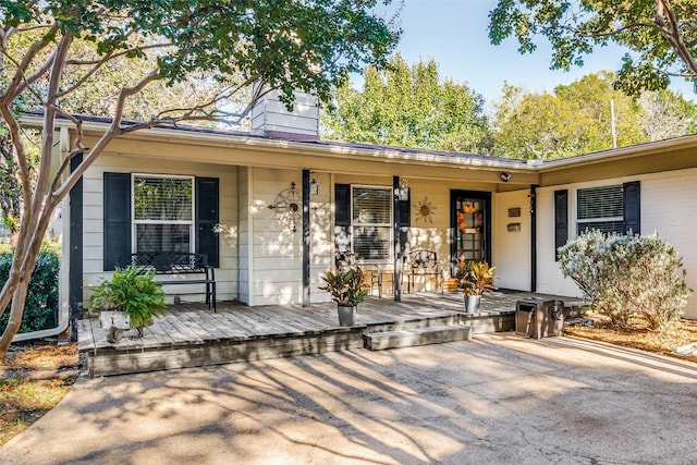 9705 Twin Creek Dr, Dallas, TX 75228 - view of front of property featuring covered porch and a chimney