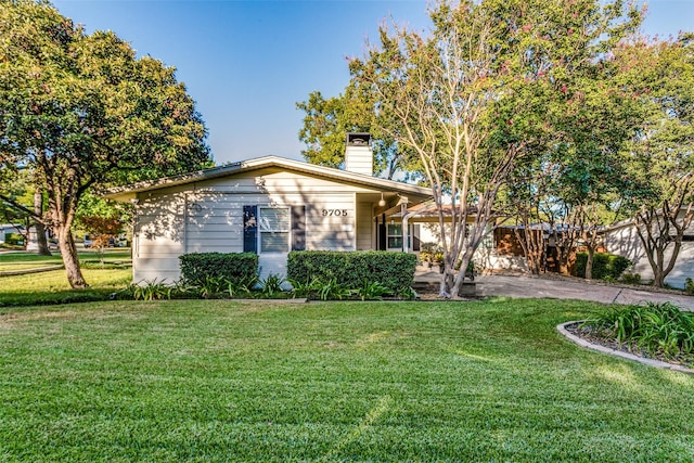 9705 Twin Creek Dr, Dallas, TX 75228 - view of front of house with a front lawn and a chimney