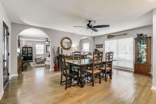 9705 Twin Creek Dr, Dallas, TX 75228 - dining room with arched walkways, ceiling fan, light wood-type flooring, and plenty of natural light