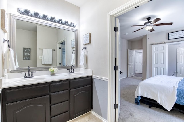 full bathroom with double vanity, a sink, ensuite bath, and a ceiling fan