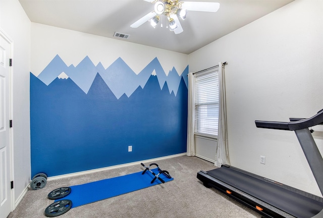 workout area with baseboards, visible vents, carpet flooring, and a ceiling fan