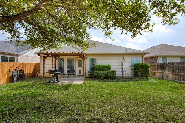 back of house featuring a fenced backyard, a pergola, a yard, and a patio