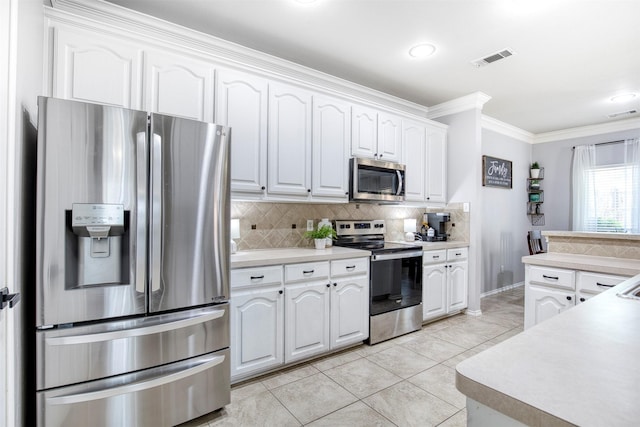 kitchen featuring crown molding, backsplash, appliances with stainless steel finishes, visible vents, and white cabinets
