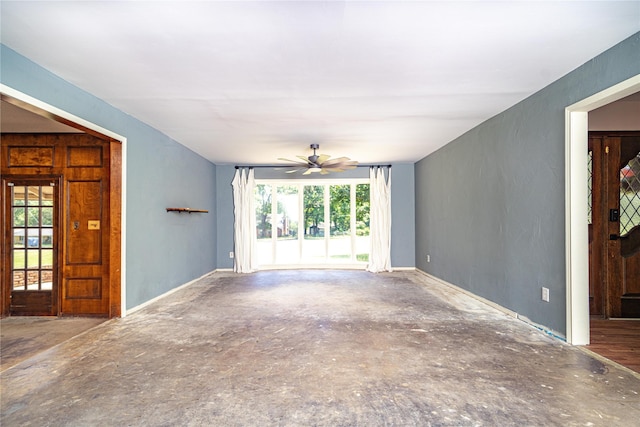 unfurnished living room featuring a ceiling fan and plenty of natural light