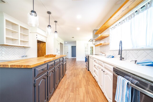 kitchen featuring white cabinets, open shelves, stainless steel appliances, wood counters, and light wood-style floors