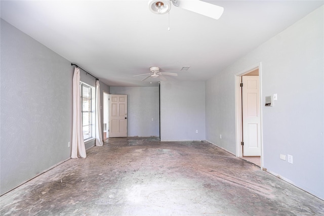 spare room featuring concrete floors and ceiling fan