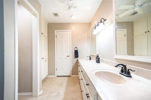 bathroom featuring a ceiling fan, a sink, double vanity, and visible vents