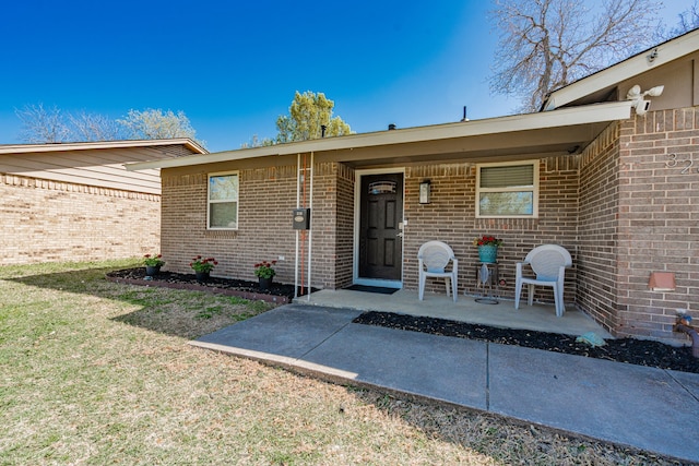 329 W Ferndale Ln, Grand Prairie, TX 75052 - entrance to property featuring brick siding and a yard