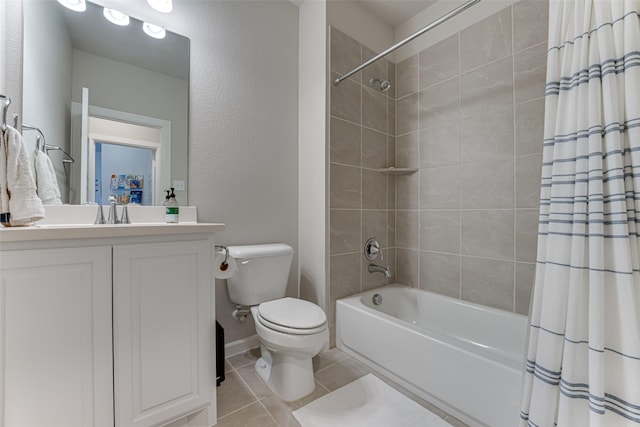 full bathroom featuring tile patterned floors, shower / tub combo with curtain, toilet, vanity, and a textured wall