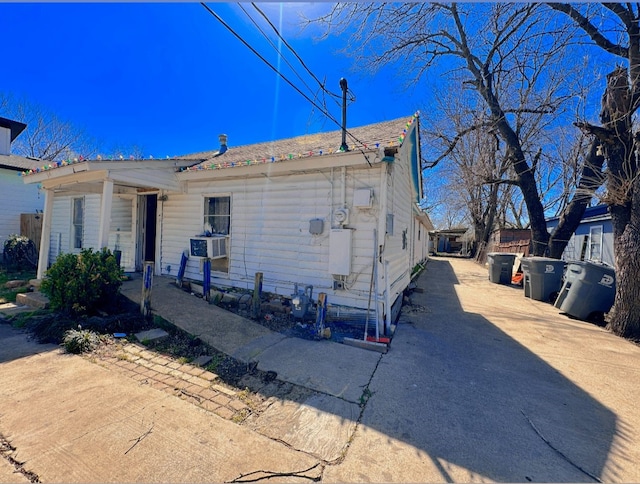 view of side of property with driveway and cooling unit