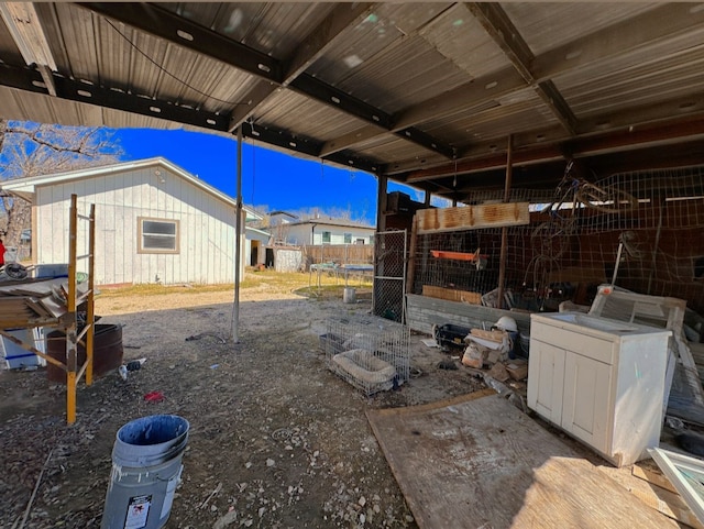 view of yard with fence, an outdoor structure, and a trampoline