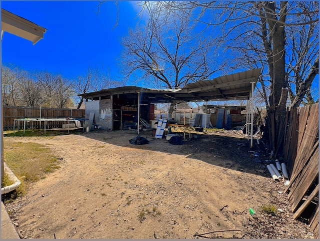 view of poultry coop with fence and a trampoline