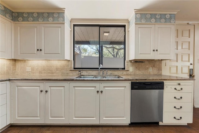 kitchen with white cabinets, a sink, stainless steel dishwasher, and tasteful backsplash