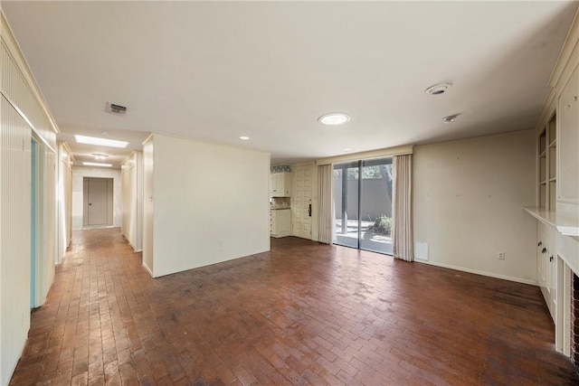 unfurnished living room with a fireplace, brick floor, baseboards, visible vents, and recessed lighting