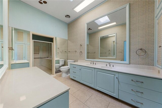 bathroom featuring tile walls, toilet, tile patterned flooring, and vanity