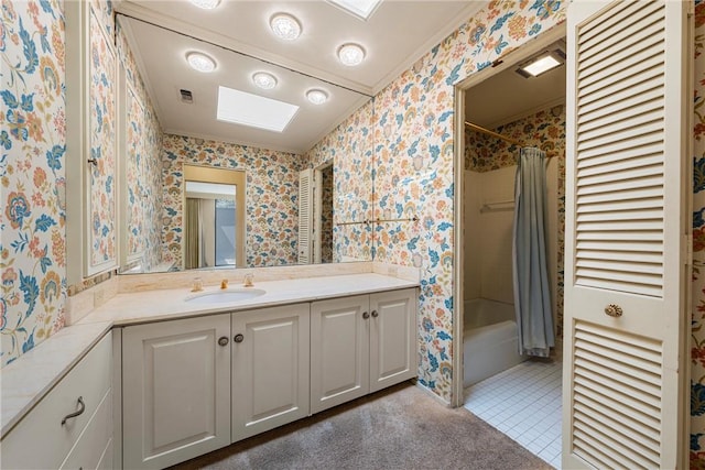 full bathroom featuring a skylight, wallpapered walls, vanity, and shower / bathtub combination with curtain
