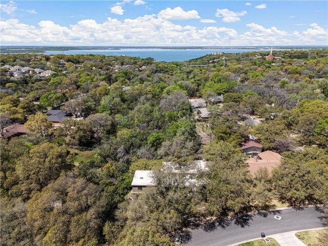 drone / aerial view with a water view and a forest view