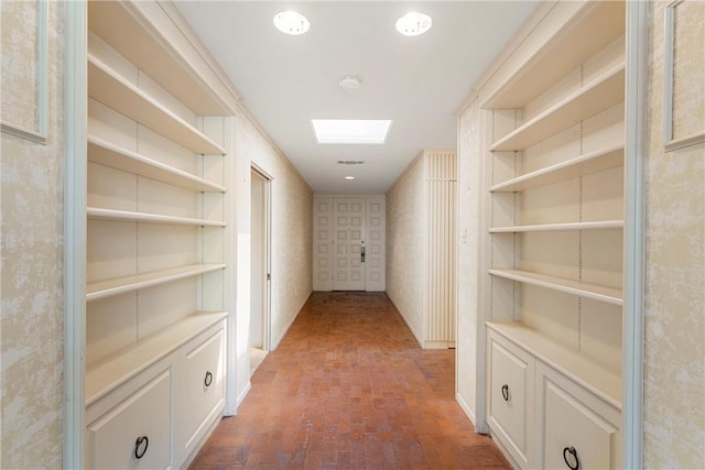 hallway with brick floor and visible vents