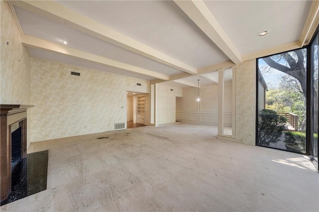 unfurnished living room featuring a fireplace, visible vents, beamed ceiling, and light carpet