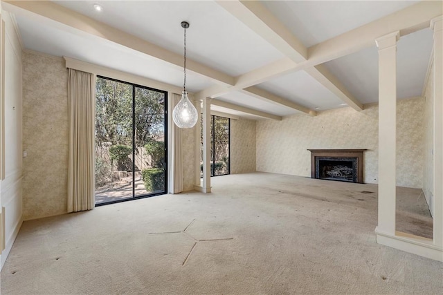 unfurnished living room featuring a fireplace, wallpapered walls, beam ceiling, and carpet flooring