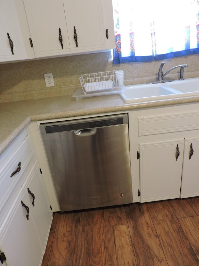 kitchen featuring a sink, light countertops, dishwasher, and dark wood-style flooring