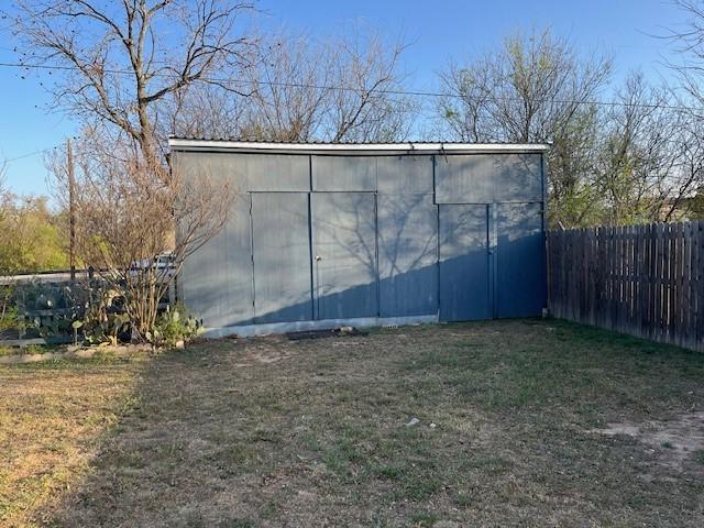 view of outbuilding with an outbuilding and fence