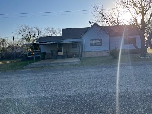 view of front of home featuring a carport and fence