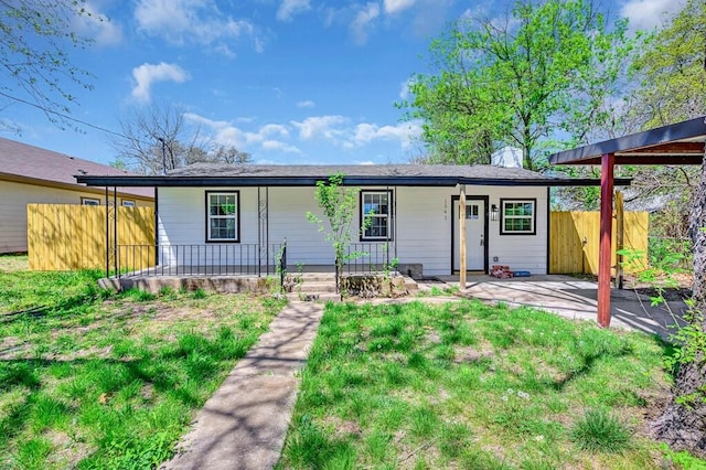 1541 Clark Ave, Waco, TX 76708 - view of front of house featuring a front lawn, covered porch, and fence