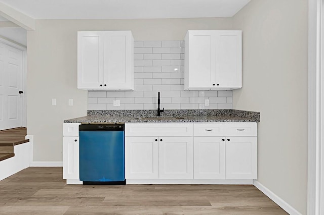 1541 Clark Ave, Waco, TX 76708 - kitchen with light wood-style flooring, a sink, dark stone counters, and dishwasher