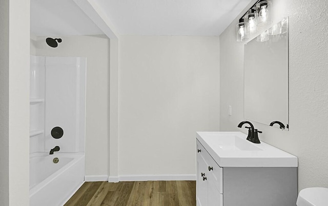 1541 Clark Ave, Waco, TX 76708 - bathroom with toilet, vanity, wood finished floors, baseboards, and shower / bath combination
