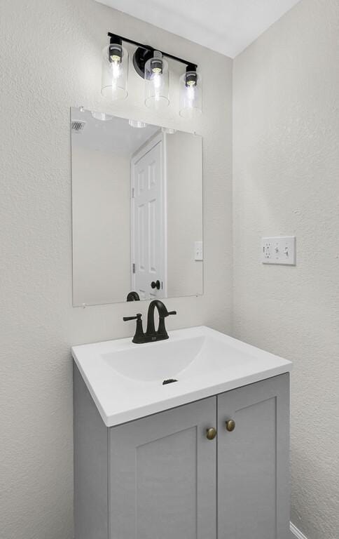 1541 Clark Ave, Waco, TX 76708 - bathroom featuring a textured wall and vanity