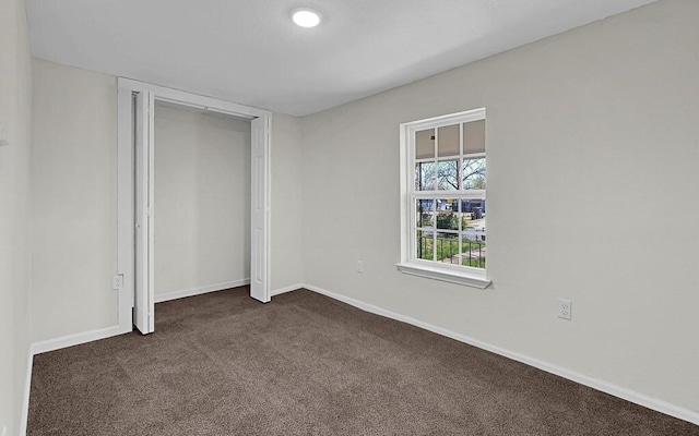 1541 Clark Ave, Waco, TX 76708 - unfurnished bedroom featuring baseboards, dark carpet, and a closet