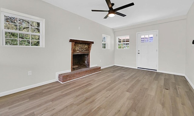 1541 Clark Ave, Waco, TX 76708 - unfurnished living room with light wood-type flooring, a brick fireplace, baseboards, and ceiling fan