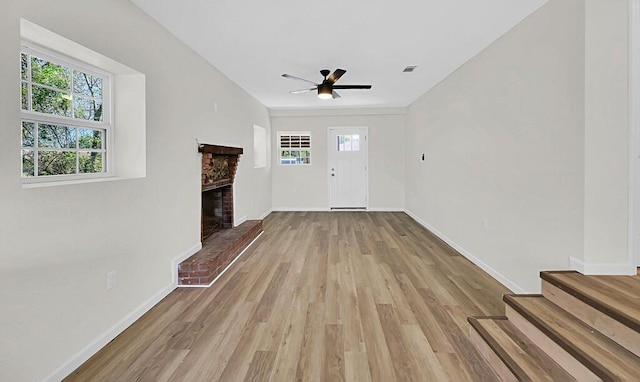 1541 Clark Ave, Waco, TX 76708 - unfurnished living room with baseboards, visible vents, a brick fireplace, ceiling fan, and wood finished floors