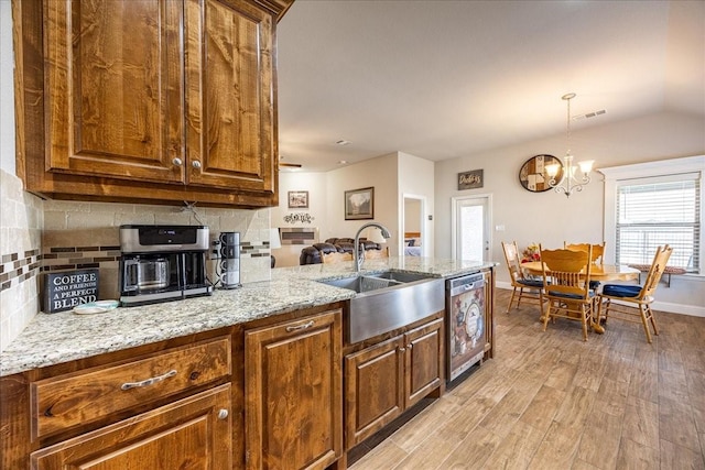 4711 Bering Dr, Sanger, TX 76266 - kitchen featuring a sink, dishwasher, tasteful backsplash, light wood finished floors, and light stone counters
