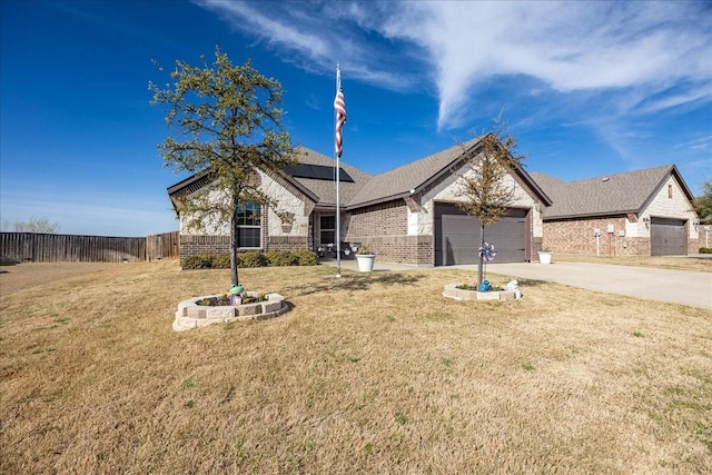 4711 Bering Dr, Sanger, TX 76266 - view of front of property featuring brick siding, solar panels, driveway, an attached garage, and roof with shingles