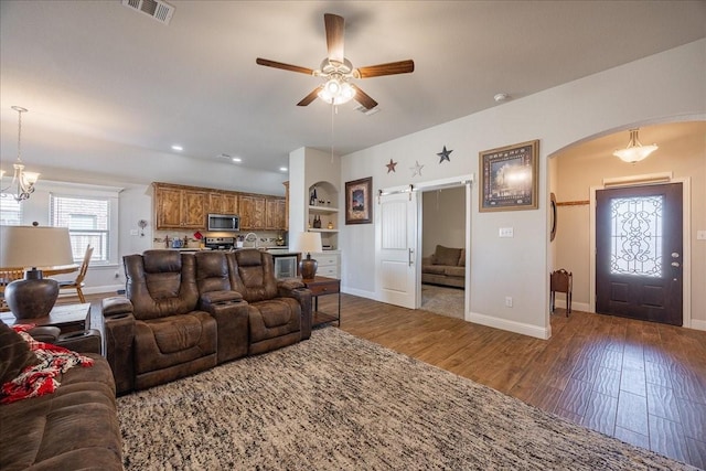 4711 Bering Dr, Sanger, TX 76266 - living area with arched walkways, wood finished floors, baseboards, a ceiling fan, and recessed lighting