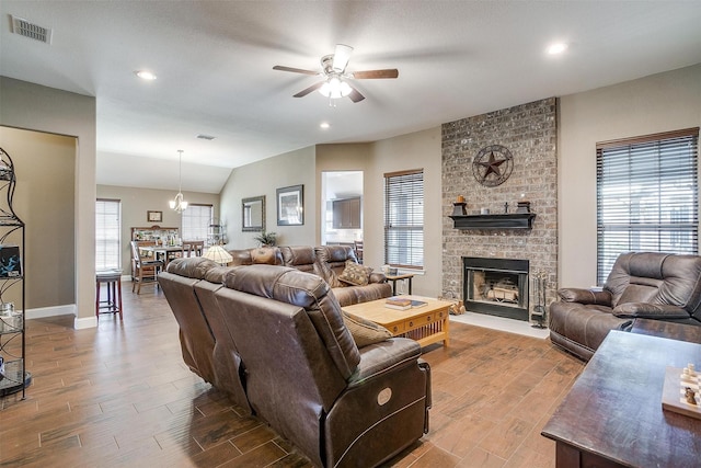 living area featuring visible vents, a fireplace, ceiling fan, wood finished floors, and recessed lighting