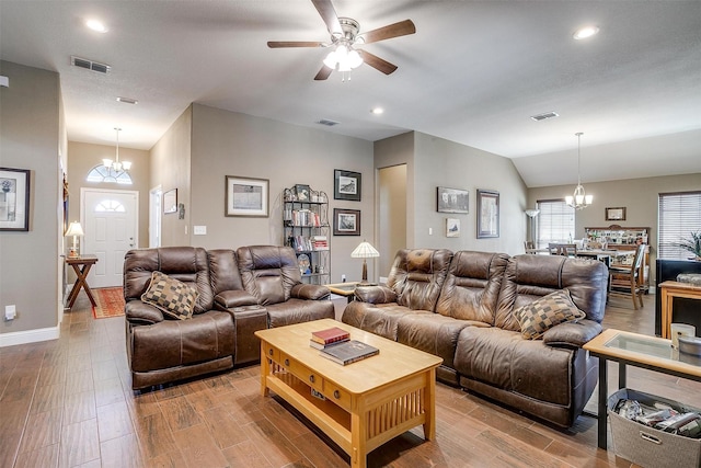 living room featuring visible vents, wood finished floors, and lofted ceiling