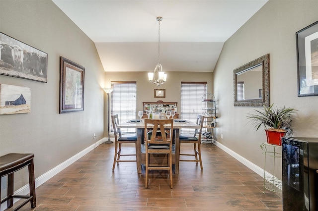 dining room featuring vaulted ceiling, baseboards, dark wood-style floors, beverage cooler, and a notable chandelier